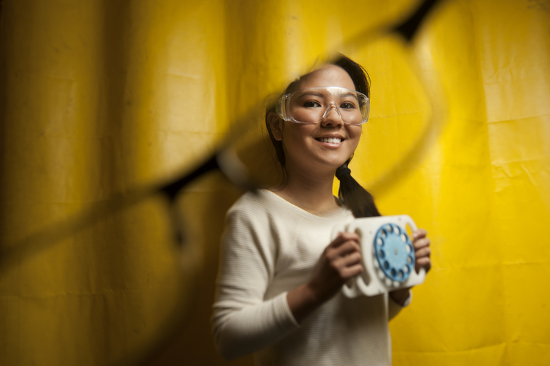 Rose Truong ’15 posing with her low-cost optometric diagnostic device