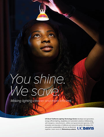 UC Davis print advertisement showing a woman looking up into a lightbulb with the text "You Shine. We Save. Making lighting cleaner and more efficient"