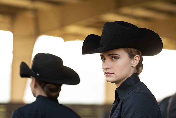 Two members of the UC Davis Equestrian team wear Western cowboy style hats. 
