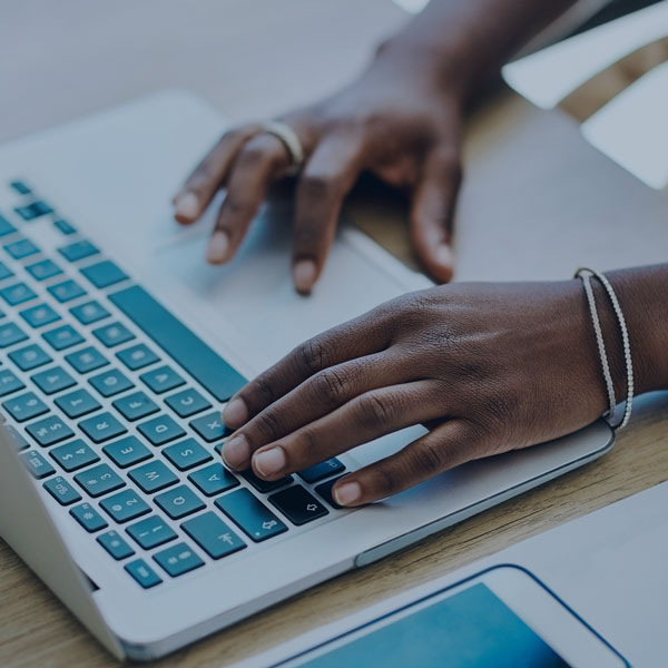 fingers typing on a laptop computer