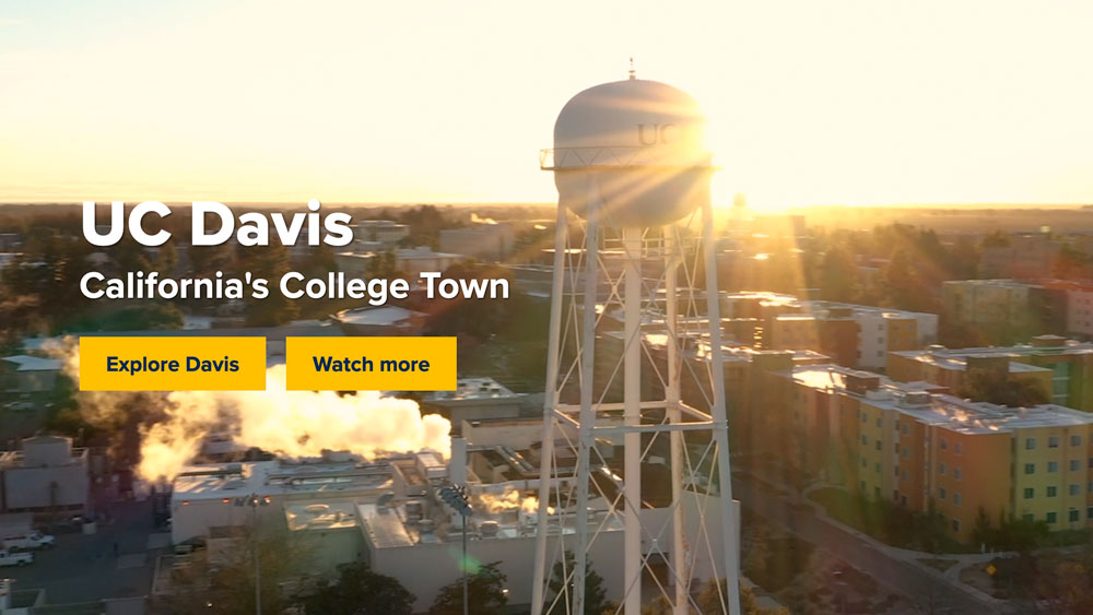 A screen capture of the UC Davs homepage featuring a title and two buttons over a drone shot of campus