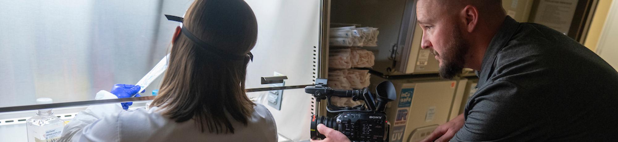 video producer filming scientist in lab